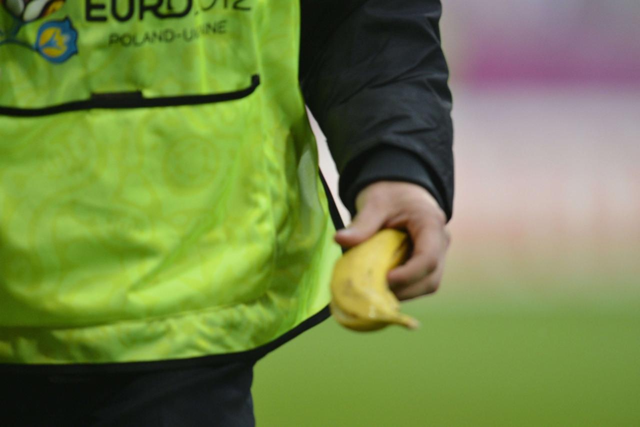'A steward holds a banana after picking it up off the pitch during the Euro 2012 football championships Group C match Italy v Croatia on June 14, 2012 at the Municipal Stadium in Poznan. Mario Balotel