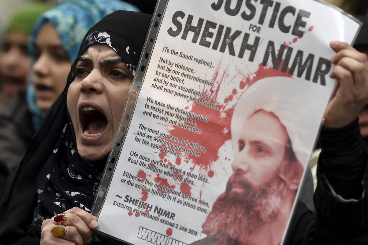 A protester holds a placard during a demonstration against the execution of Shi'ite cleric Sheikh Nimr al-Nimr in Saudi Arabia, outside the Saudi Arabian Embassy in London, Britain, January 3, 2016. REUTERS/Toby Melville