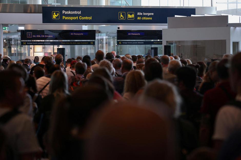 Travellers queue at passport control in Copenhagen Airport Kastrup in Copenhagen