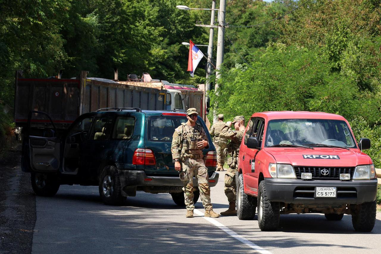 U.S. troops part of KFOR are seen as trucks block a road in Zupce