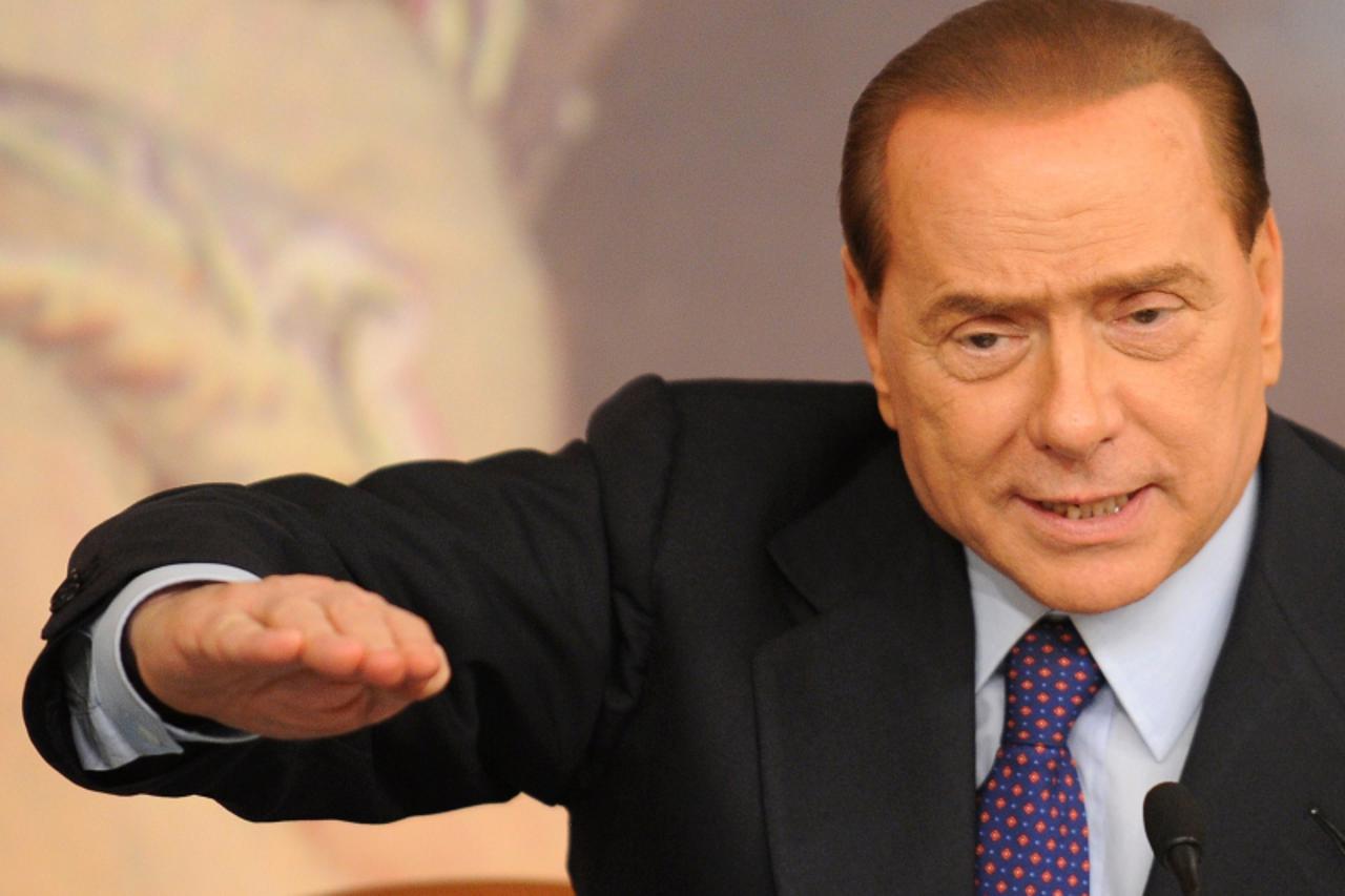 'Italy\'s Prime Minister Silvio Berlusconi answers journalists\' questions during a press conference at Chigi palace in Rome on May 26, 2010.  Italian Prime Minister Silvio Berlusconi  said sacrifices