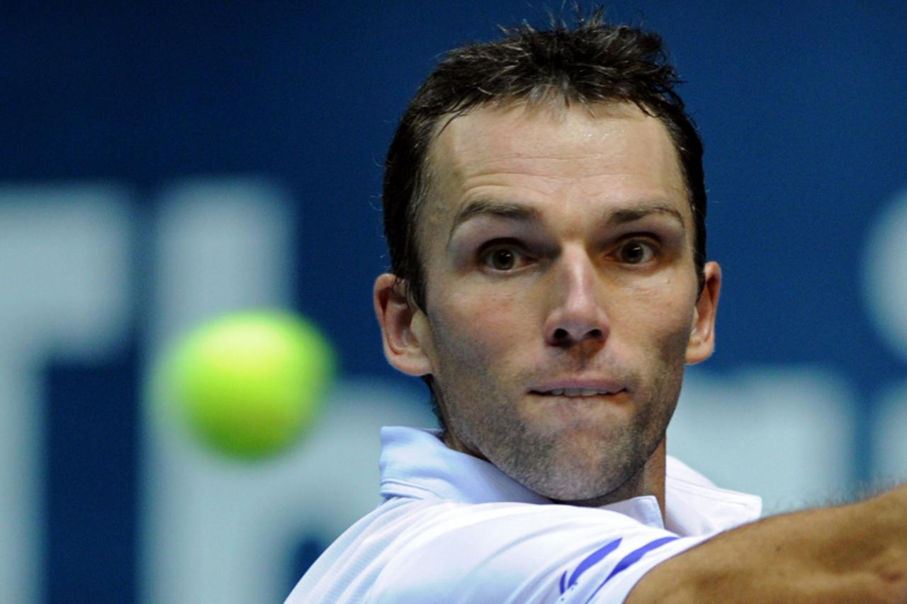 'Ivo Karlovic of Croatia plays a shot against Milos Raonic of Canada during their men\'s singles second round match at the ATP PTT Thailand Open tennis tournament in Bangkok on September 27, 2012.  AF