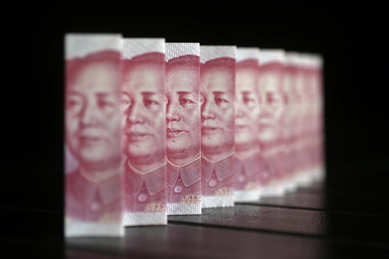 'Chinese 100 yuan banknotes are seen in this file picture illustration taken in Beijing July 11, 2013. The Chinese yuan edged higher on July 31, 2013 as traders reported corporate dollar selling, an i