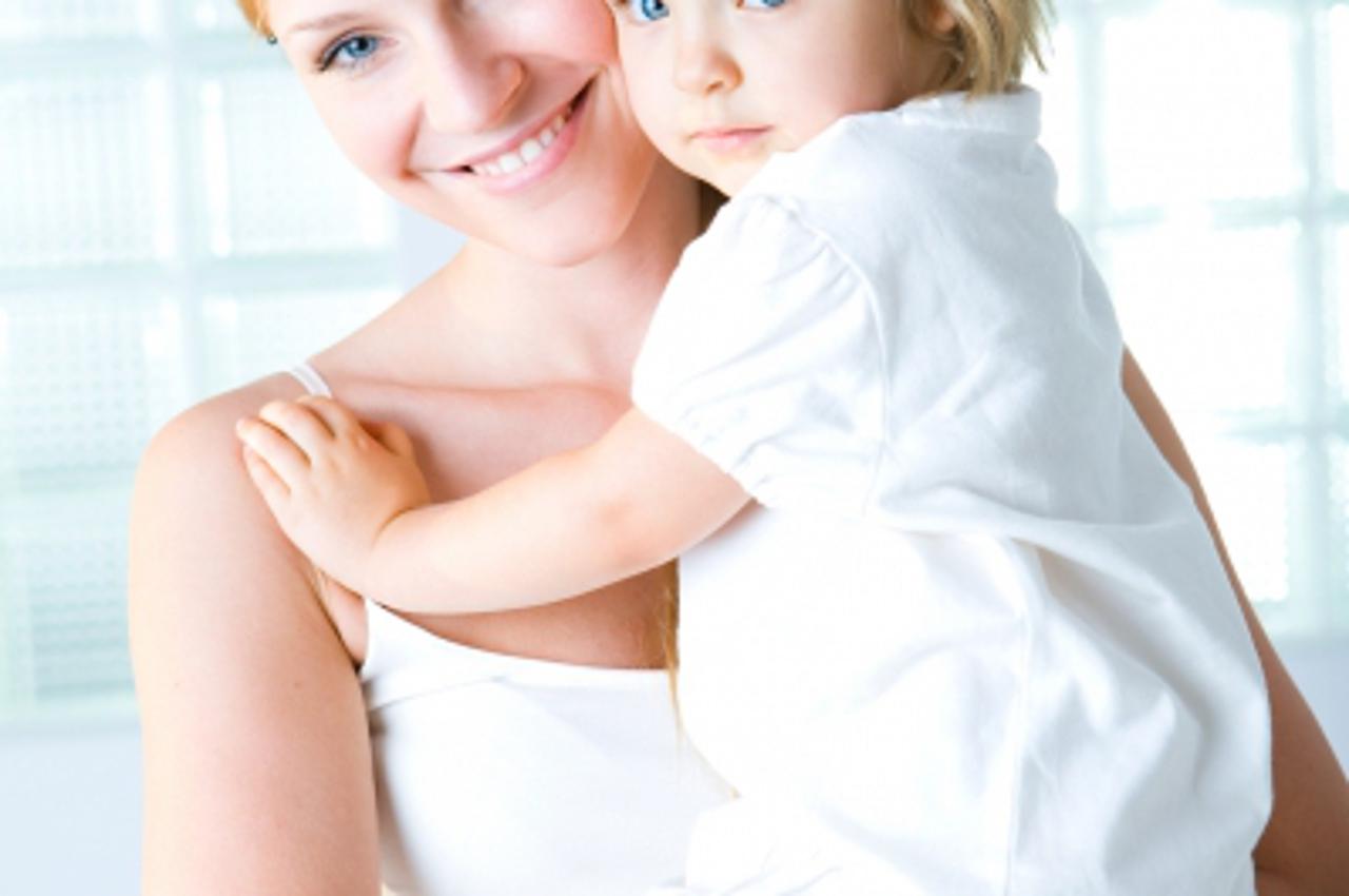 \'Mother holding toddler daughter\'