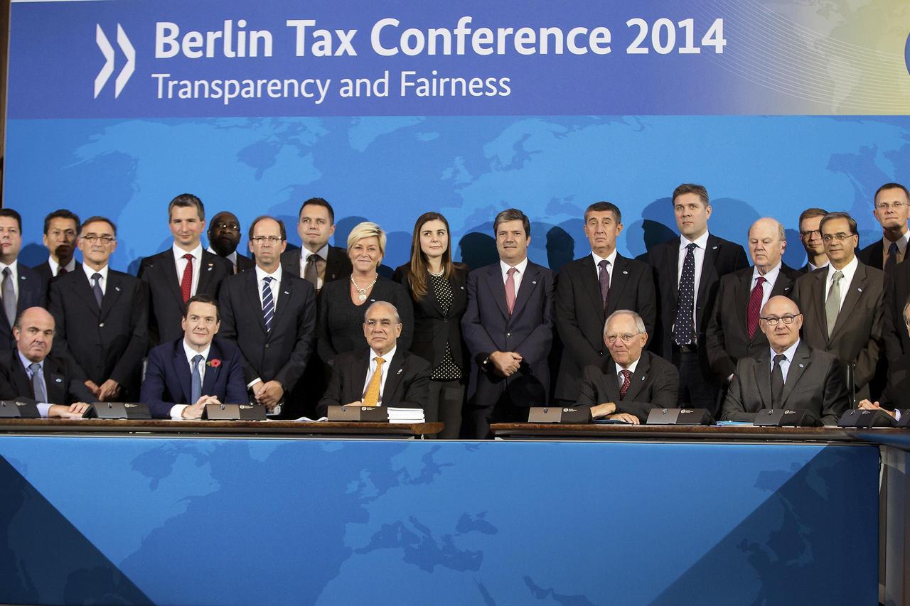 Finance ministers and tax chiefs pose for a family picture in Berlin October 29, 2014. Finance ministers and tax chiefs from 50 countries signed an agreement in Berlin on Wednesday to automatically swap tax information as part of the Organisation for Econ