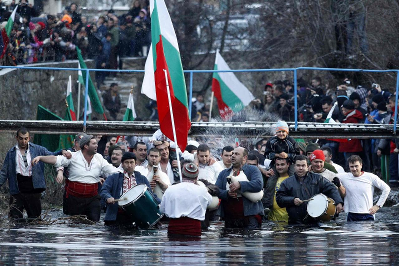 'Bulgarian men dance in the icy waters of the Tundzha river during a celebration for Epiphany Day in the town of Kalofer, some 150 km (93 miles) east of Sofia January 6, 2013. It is believed that the 