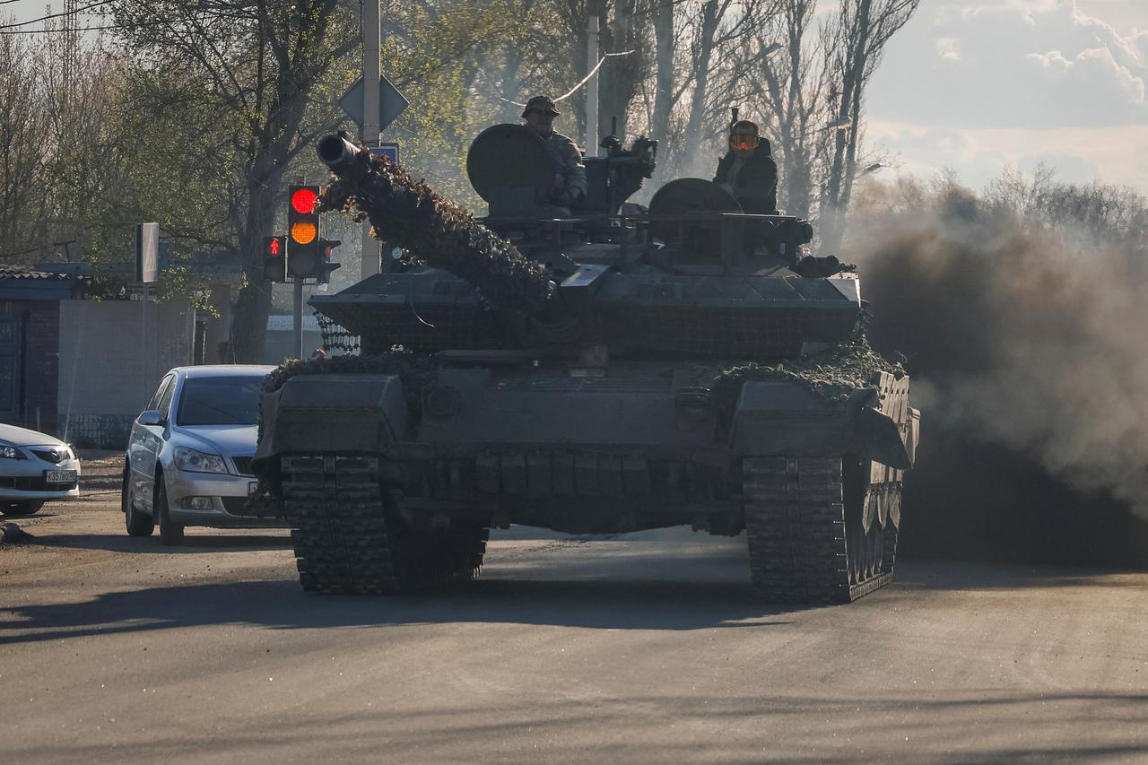 Russian army servicemed drive a tank on a street in Donetsk