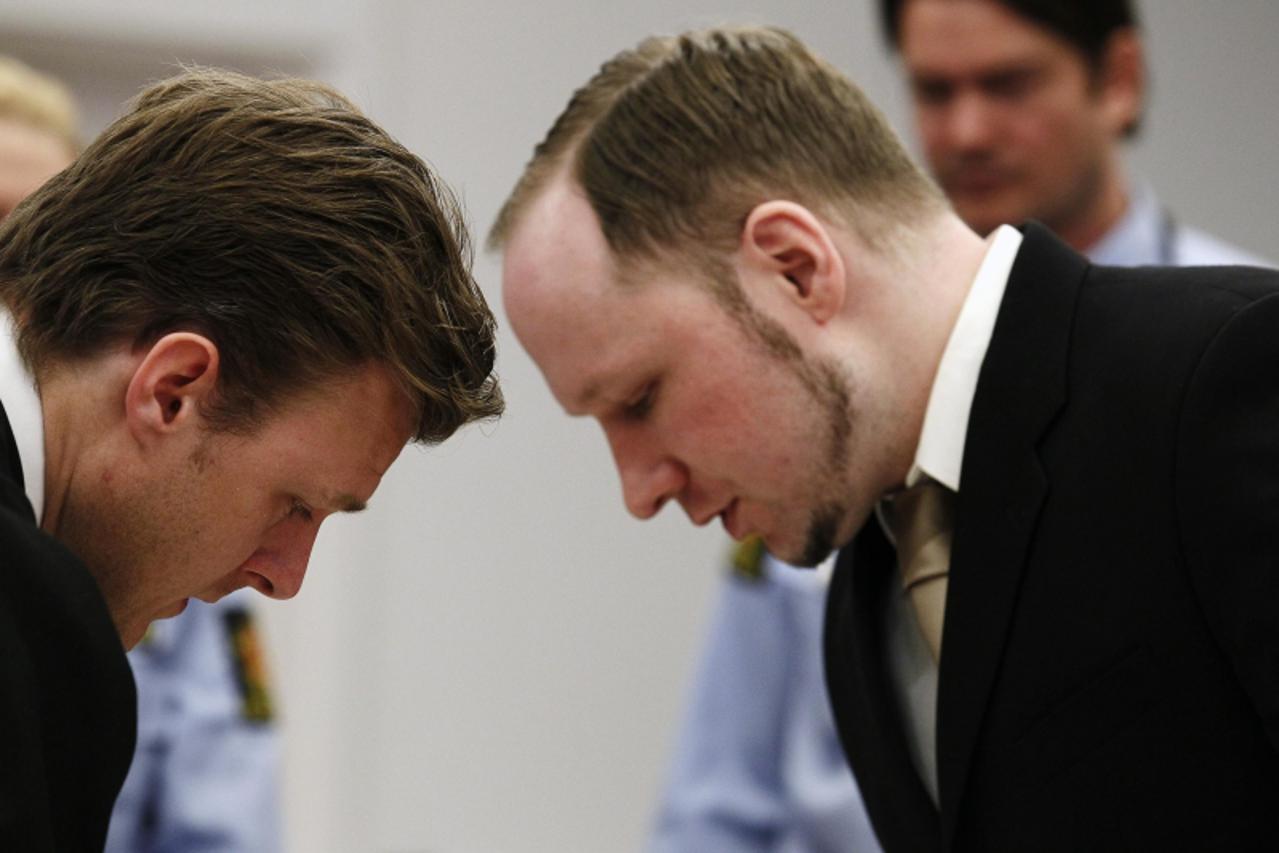 'Norwegian mass killer Anders Behring Breivik (R) confers with Tord Jordet, a member of his defence team, in courtroom 250 during the second day of his terrorism and murder trial in Oslo April 17, 201