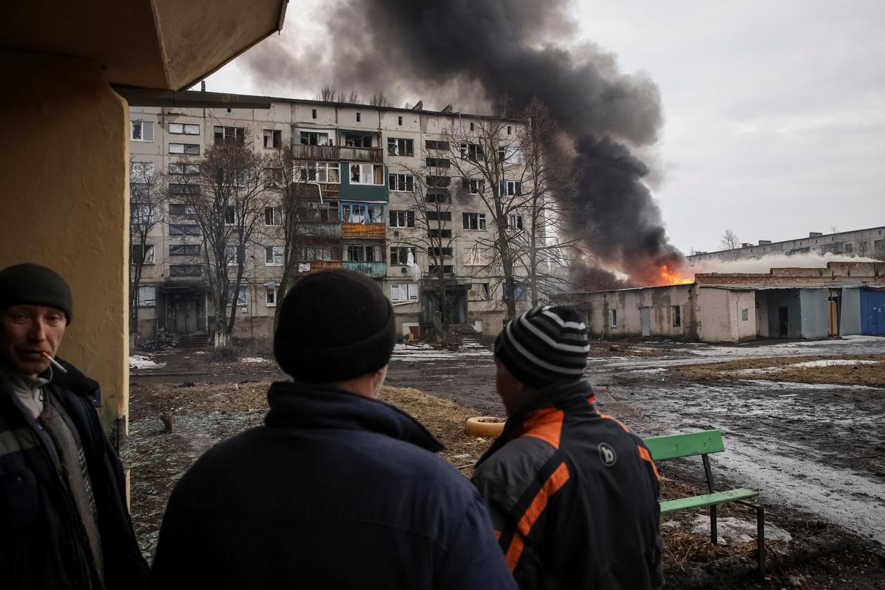 Local residents look at a buildings damaged by a Russian military strike in Chasiv Yar