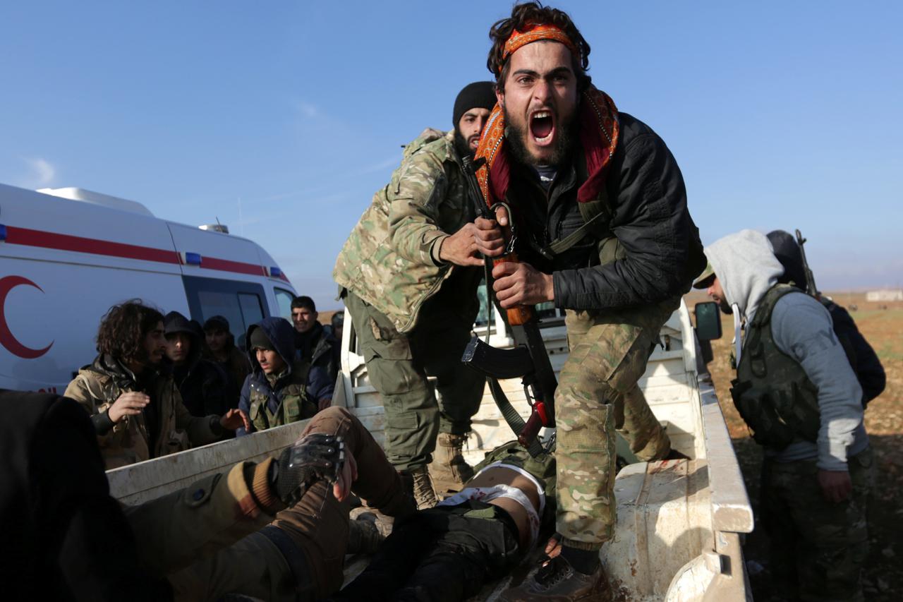 A Free Syrian Army (FSA) fighter reacts as he mourns near the body of his brother, who was an FSA fighter and died during an offensive against Islamic State fighters to take control of Qabasin town, on the outskirts of the northern Syrian town of al-Bab, 