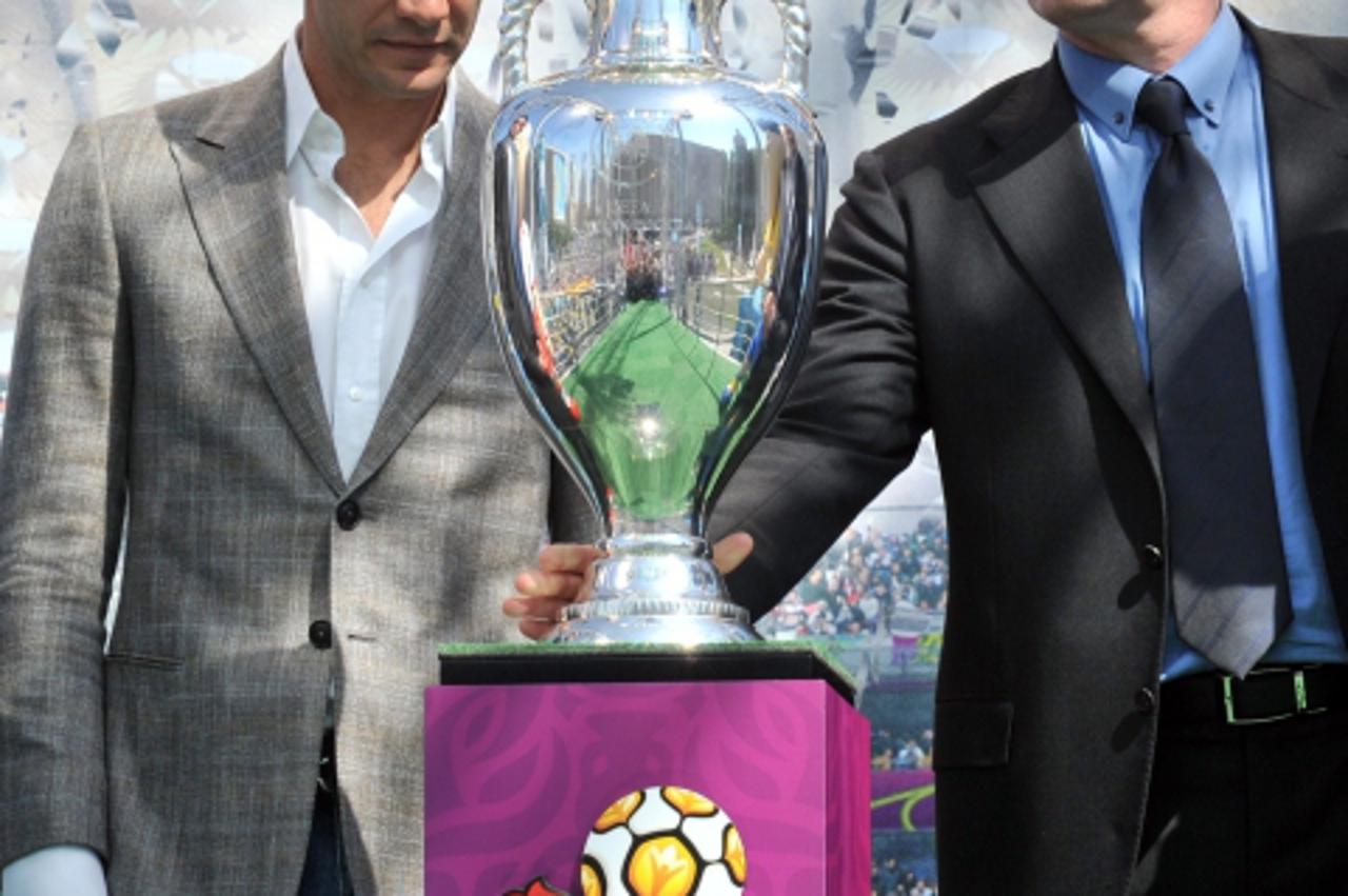'Former  football player, UEFA ambassador Davor Suker (R) and the Ukrainian  National football team captain Andriy Shevchenko attend at EURO 2012 tournament cup during the ceremony of the presentation