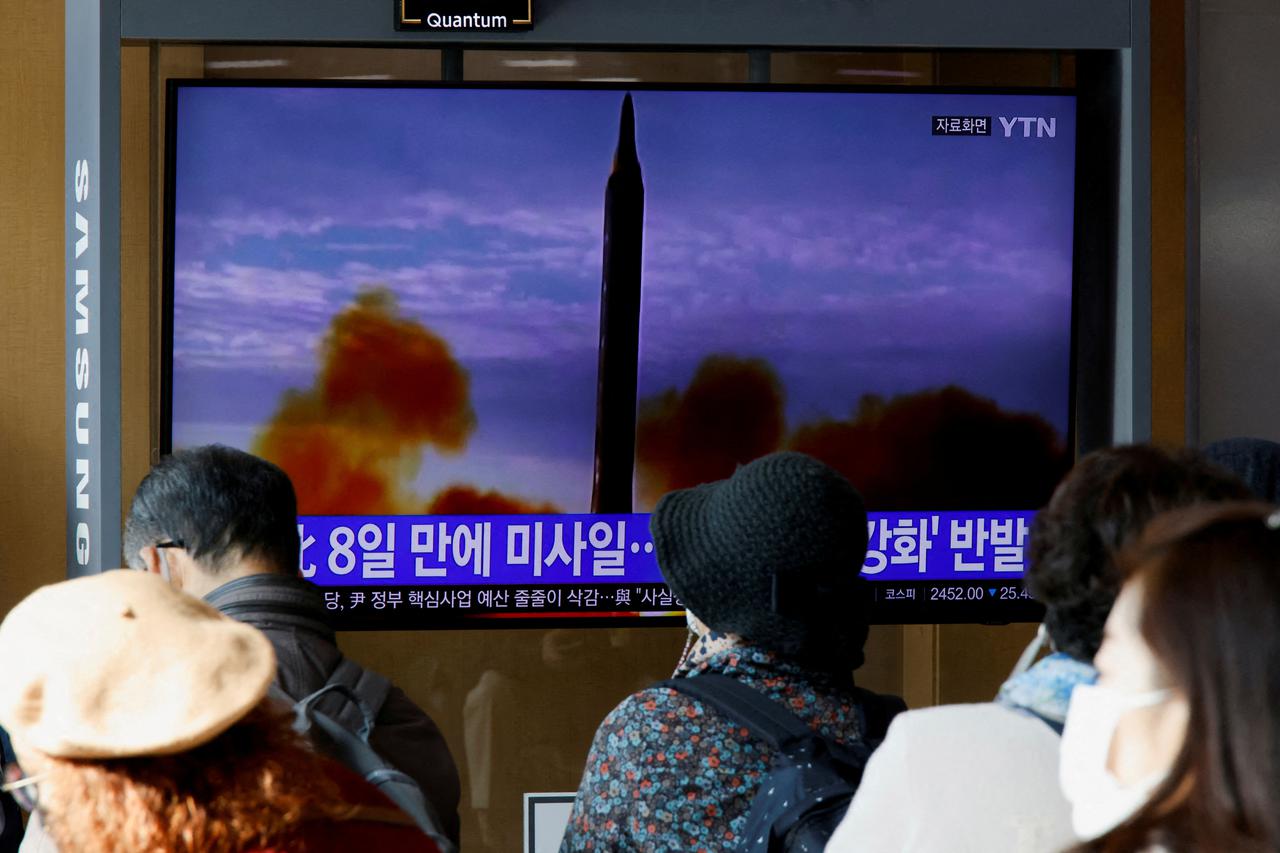 FILE PHOTO: People watch a TV broadcasting a news report, on North Korea firing a ballistic missile off its east coast, in Seoul