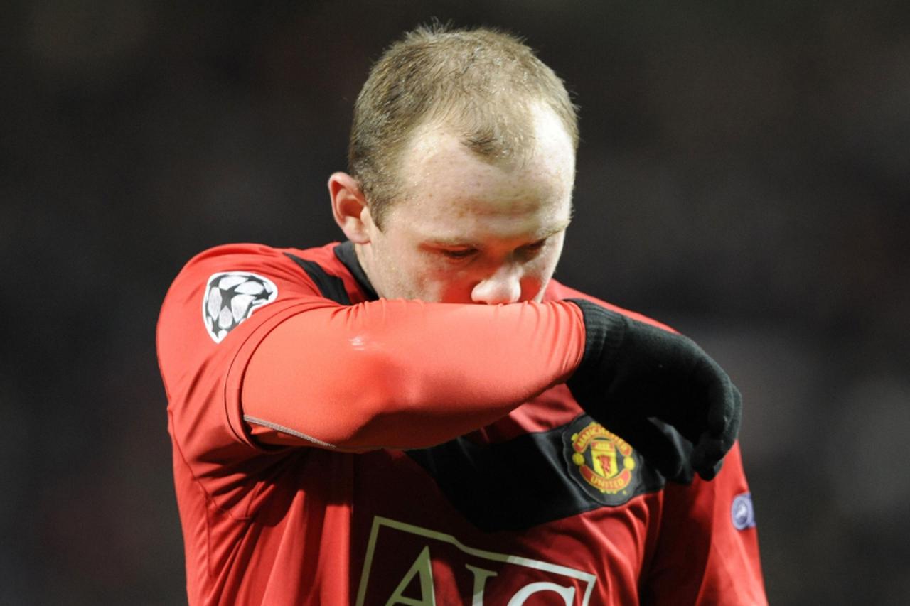 'Manchester United\'s Wayne Rooney wipes his face as he leaves the pitch at half-time during their Champions League quarter-final second leg soccer match against Bayern Munich at Old Trafford in Manch