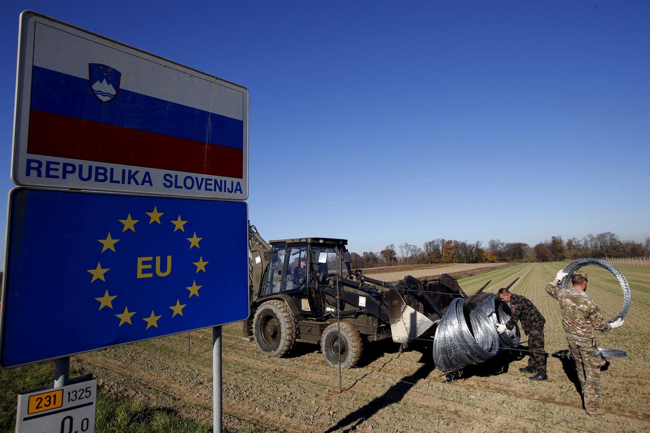 Slovenian soldiers set up barbed wire barriers in the village Gibina, Slovenia, November 11, 2015. Trucks carrying wire fencing arrived in the Slovenian village of Gibina close to the border with Croatia early on Wednesday, a day after the government said