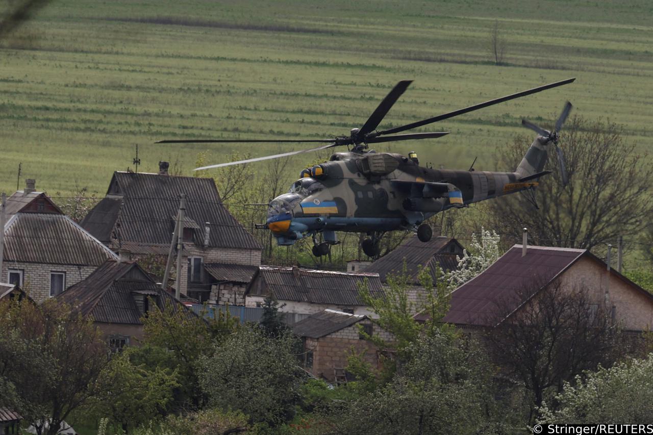 Ukrainian military helicopter flies over a village in Donetsk region