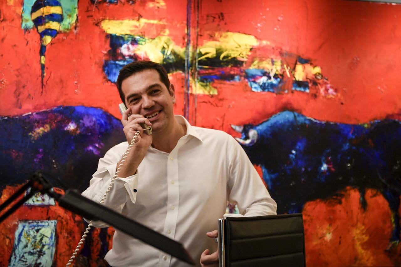 Leftist Syriza party leader and winner of the Greek general elections Alexis Tsipras talks on the phone at this office at the party's headquarters in this handout photo released by the Syriza press office in Athens, Greece September 20, 2015. Greek leftis