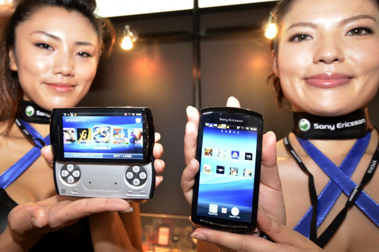 'Models display Sony Ericsson\'s smartphone Xperia Play at the annual Tokyo Game Show in Chiba, suburban Tokyo, on September 15, 2011. Some 200 companies from 16 countries exhibited their latest video