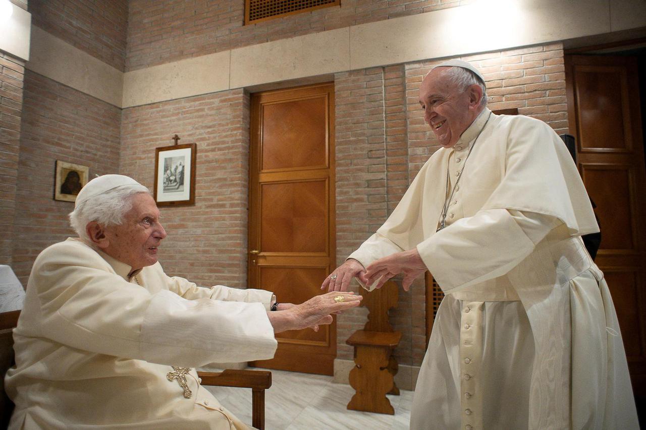 FILE PHOTO: Pope Francis and Pope Emeritus Benedict XVI meet with new cardinals at the Vatican