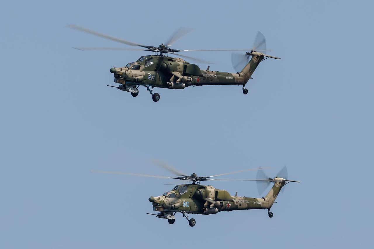Russian Mil Mi-28N military helicopters perform a flight during the Aviadarts competition outside Ryazan