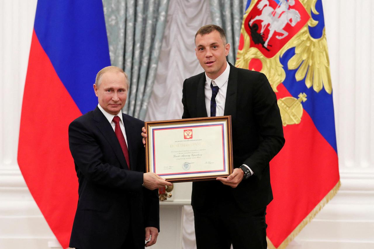 FILE PHOTO: Russia's President Putin poses with Russia's national soccer team player Dzyuba at the Kremlin in Moscow