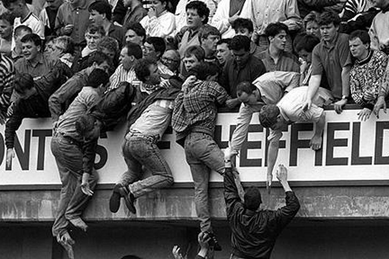 'SAFRICA Stampede/Hillsborough 3...File photo dated 15/4/89 of Liverpool fans trying to escape severe overcrowding at the FA Cup semi-final football match between Liverpool and Nottingham Forest at Hi