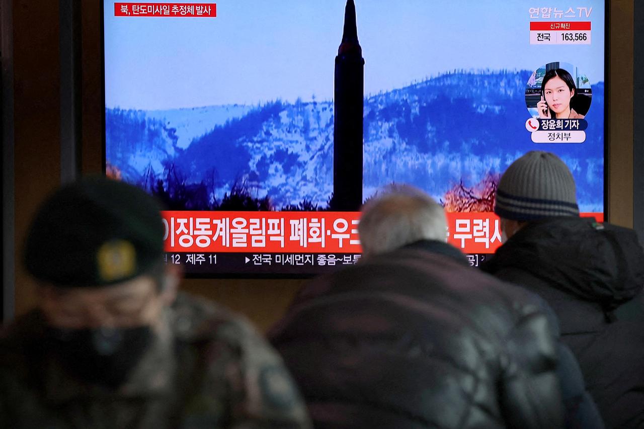 FILE PHOTO: FILE PHOTO: People watch a TV broadcasting file footage of a news report on North Korea firing what appeared to be a ballistic missile, in Seoul