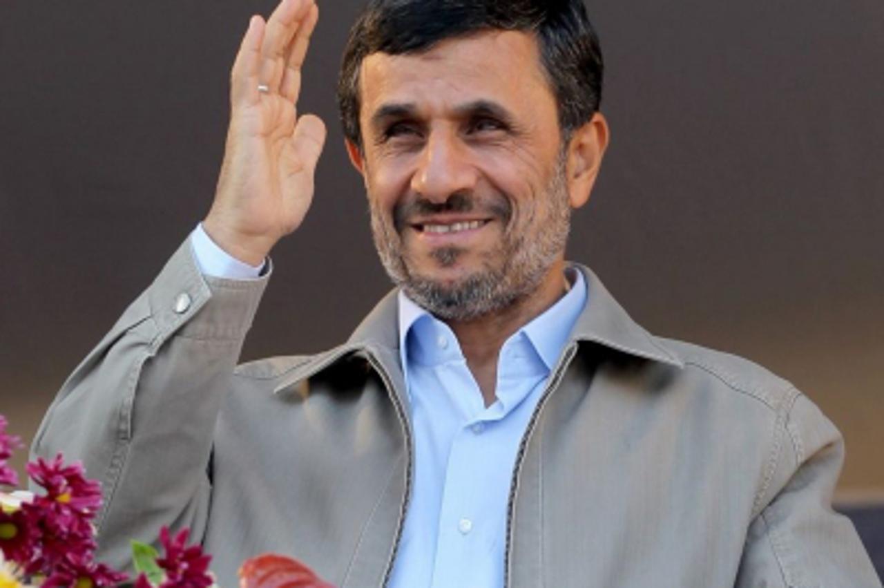 'Iranian President Mahmoud Ahmadinejad waves in Pakdasht, southeast of Tehran November 23, 2011. Ahmadinejad on Wednesday denounced European countries that are tightening sanctions on Iran as puppets 