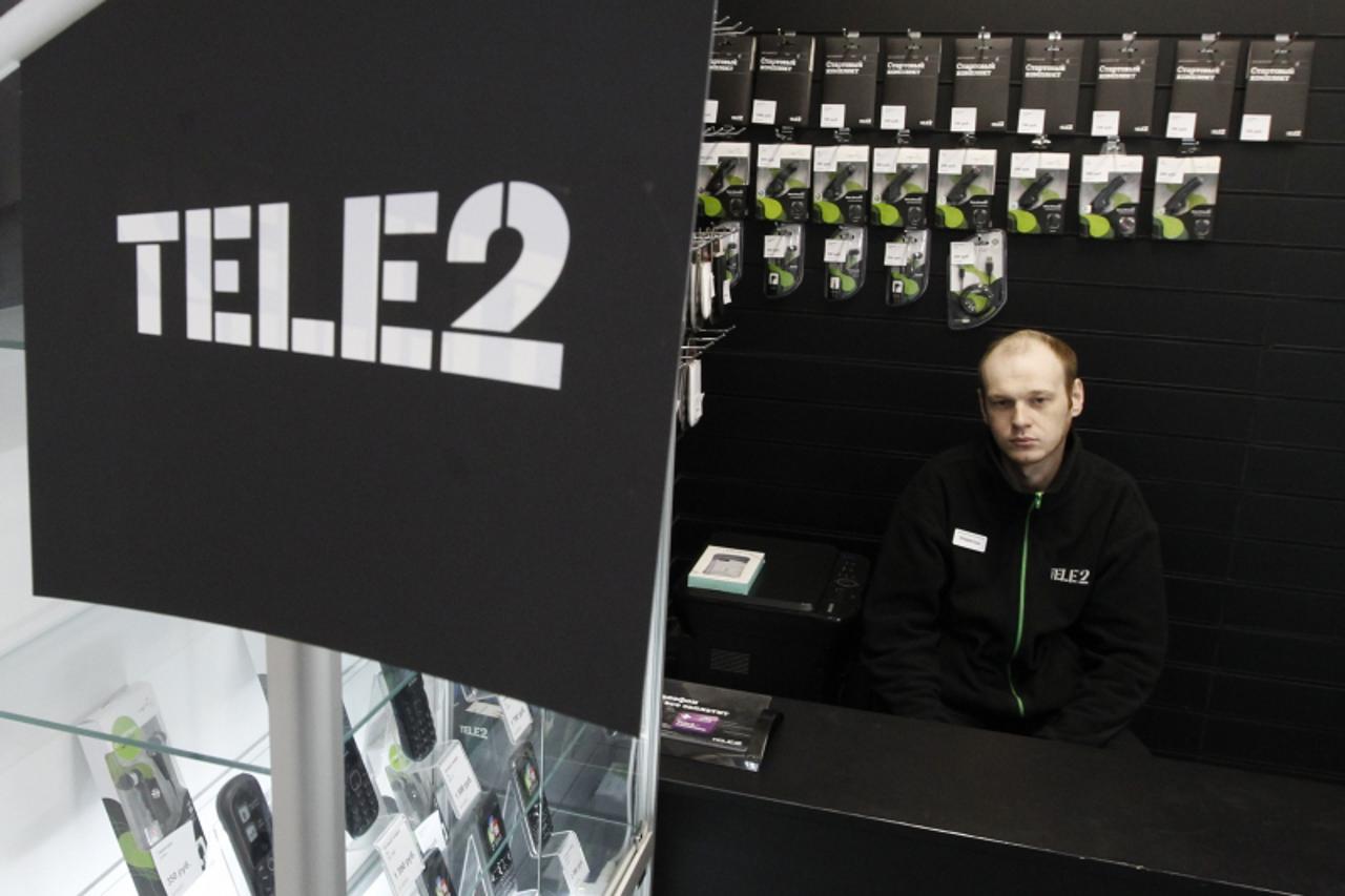 'A shop assistant looks on from inside a Tele2 company's sales office in St. Petersburg, March 28, 2013. Mobile phone firms MTS and Vimpelcom remain interested in Tele2's Russian unit even after the