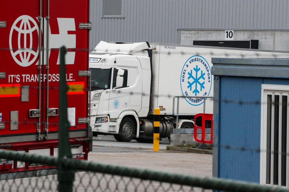 A refrigerated truck is seen on the back side of the Pfizer factory in Puurs