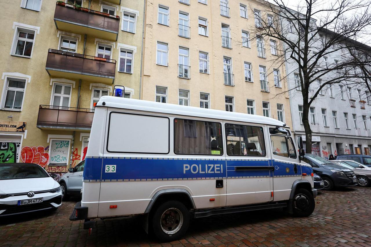 A German police vehicle is parked in front of an apartment building during a raid against people supporting the Palestinian Islamist group Hamas, in Berlin