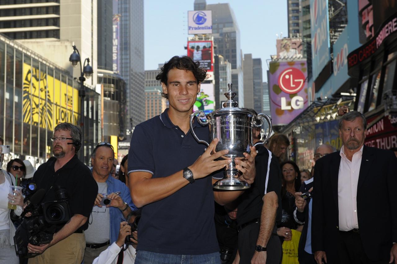'Rafael Nadal from Spain poses with his trophy in Times Square September 14, 2010, the morning after winning  the Men\'s Singles Final at the US Open 2010 at the USTA Billie Jean King National Tennis 