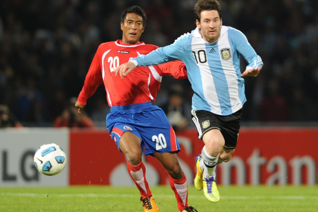 'Argentine forward Lionel Messi (R) is marked by Costa Rican defender Pedro Leal during a 2011 Copa America Group A first round football match held at the Mario Kempes stadium in Cordoba, 770 Km north
