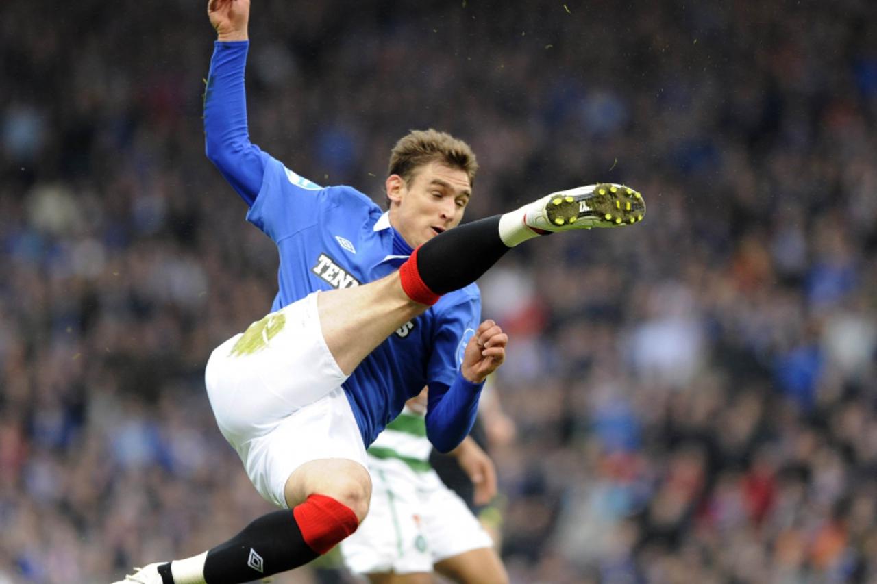 \'Rangers\' Nikica Jelavic shoots against Celtic during their Scottish League Cup Final soccer match at Hampden Park ,Glasgow, Scotland, March 20, 2011. REUTERS/Russell Cheyne (BRITAIN - Tags: SPORT S