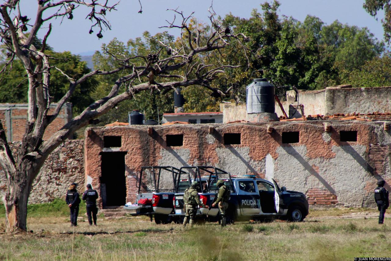 Authorities work at the scene of an attack at a posada, in Salvatierra