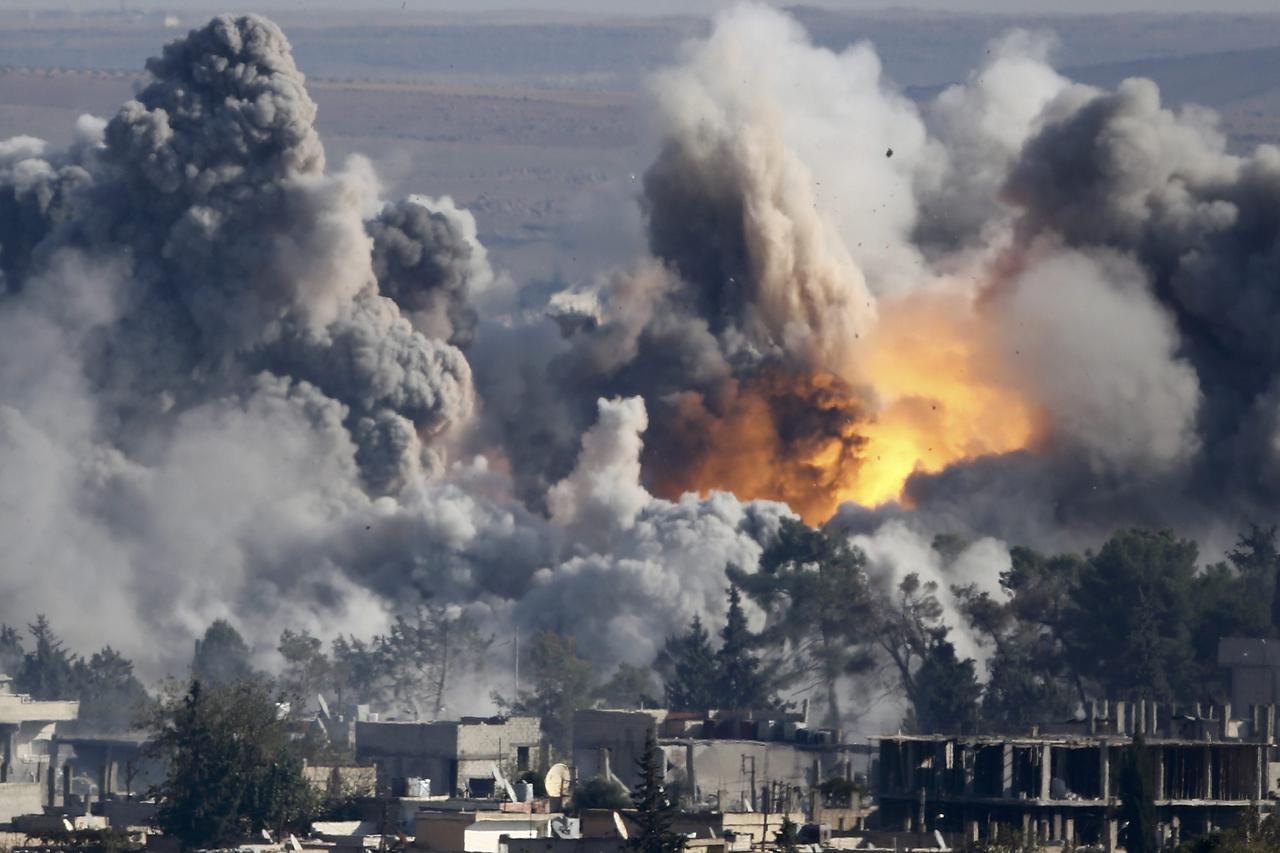 Smoke rises over Syrian town of Kobani after an airstrike, as seen from the Mursitpinar border crossing on the Turkish-Syrian border in the southeastern town of Suruc in Sanliurfa province, October 18, 2014. A U.S.-led military coalition has been bombing 