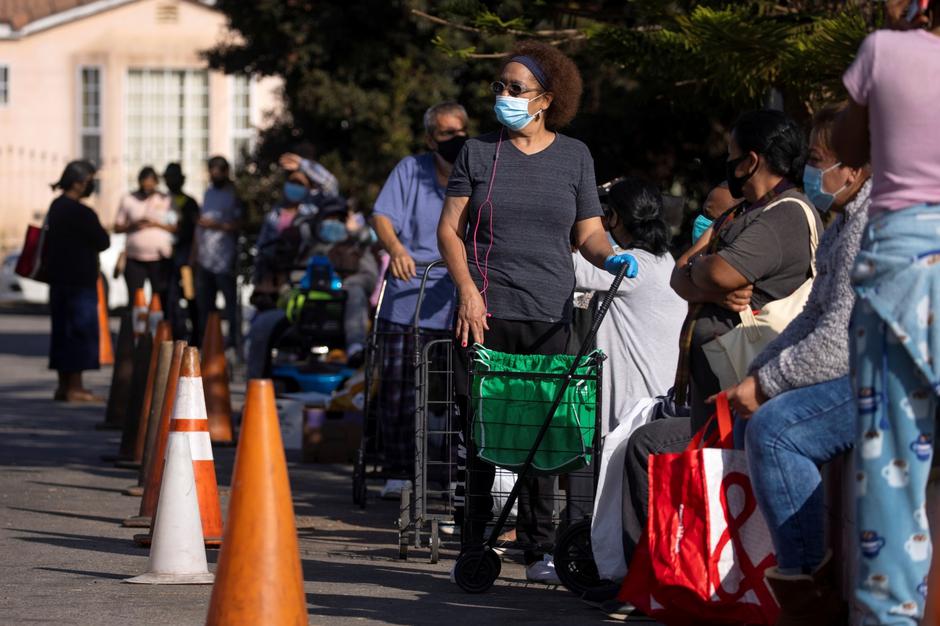 People wait in line as the Los Angeles Regional Food Bank distributes food outside a church during the outbreak of the coronavirus disease (COVID-19) in Los Angeles