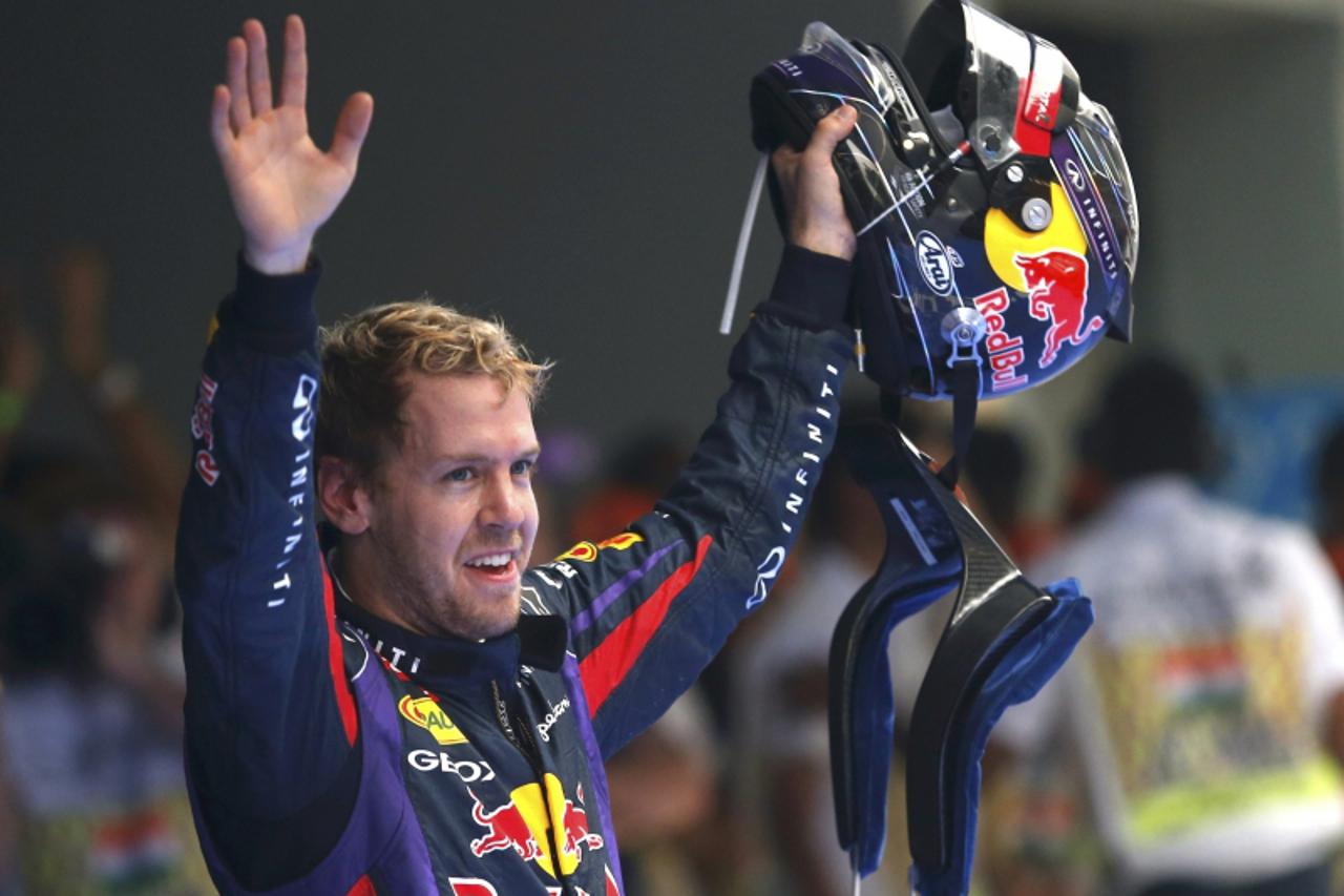 'Red Bull Formula One driver Sebastian Vettel (C) of Germany celebrates winning the Indian F1 Grand Prix at the Buddh International Circuit in Greater Noida, on the outskirts of New Delhi, October 27,
