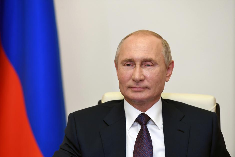 Russian President Vladimir Putin takes part in a video conference call outside Moscow