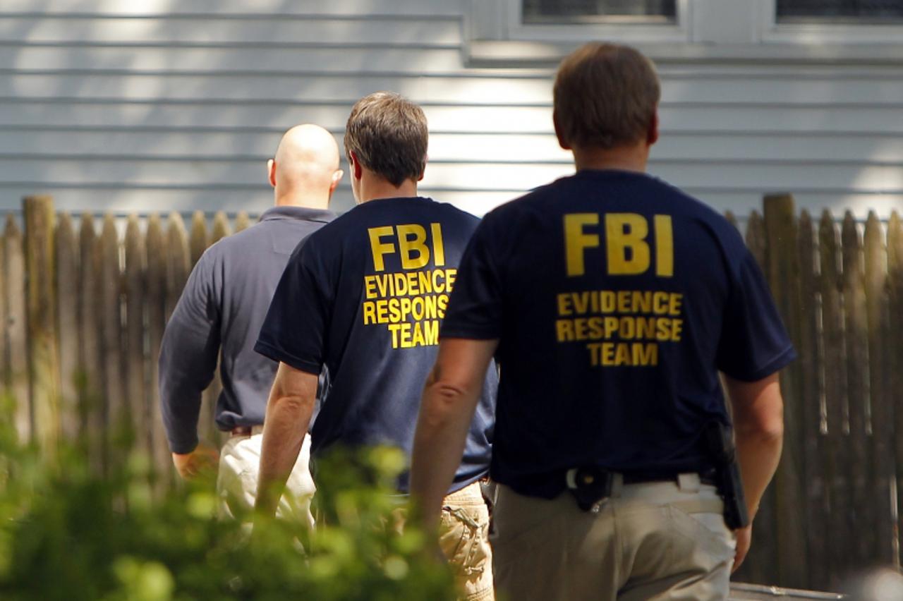 'FBI agents are seen outside 39 Waverly Avenue, where earlier in the day they raided the home in Watertown, Massachusetts May 13, 2010. U.S. authorities raided locations in New York, Boston and Philad