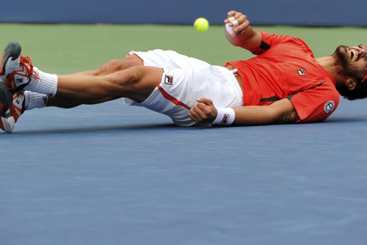 'Janko Tipsarevic of Serbia lies on the court after he slipped and fell in his men\'s singles quarterfinals match against David Ferrer of Spain at the U.S. Open tennis tournament in New York September