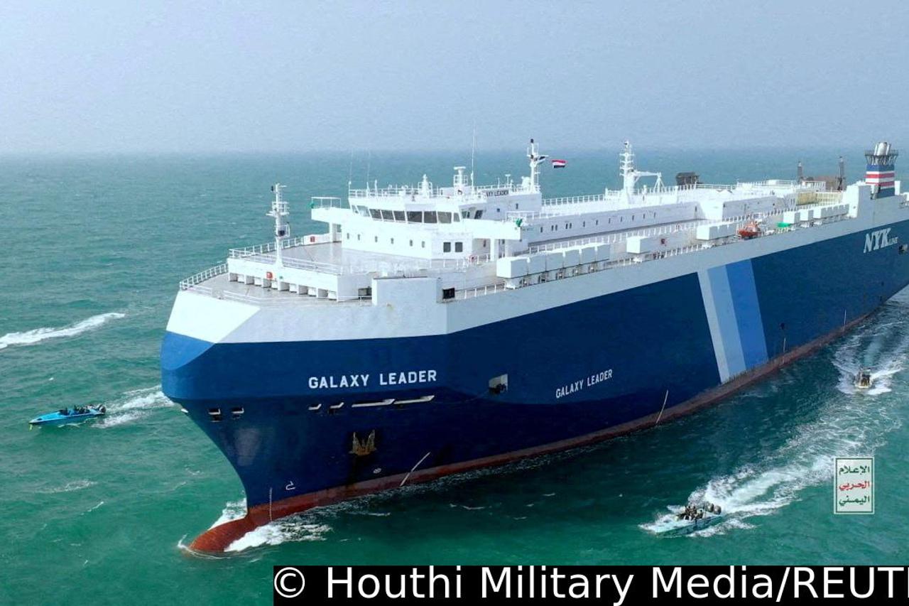 FILE PHOTO: The Galaxy Leader cargo ship is escorted by Houthi boats in the Red Sea