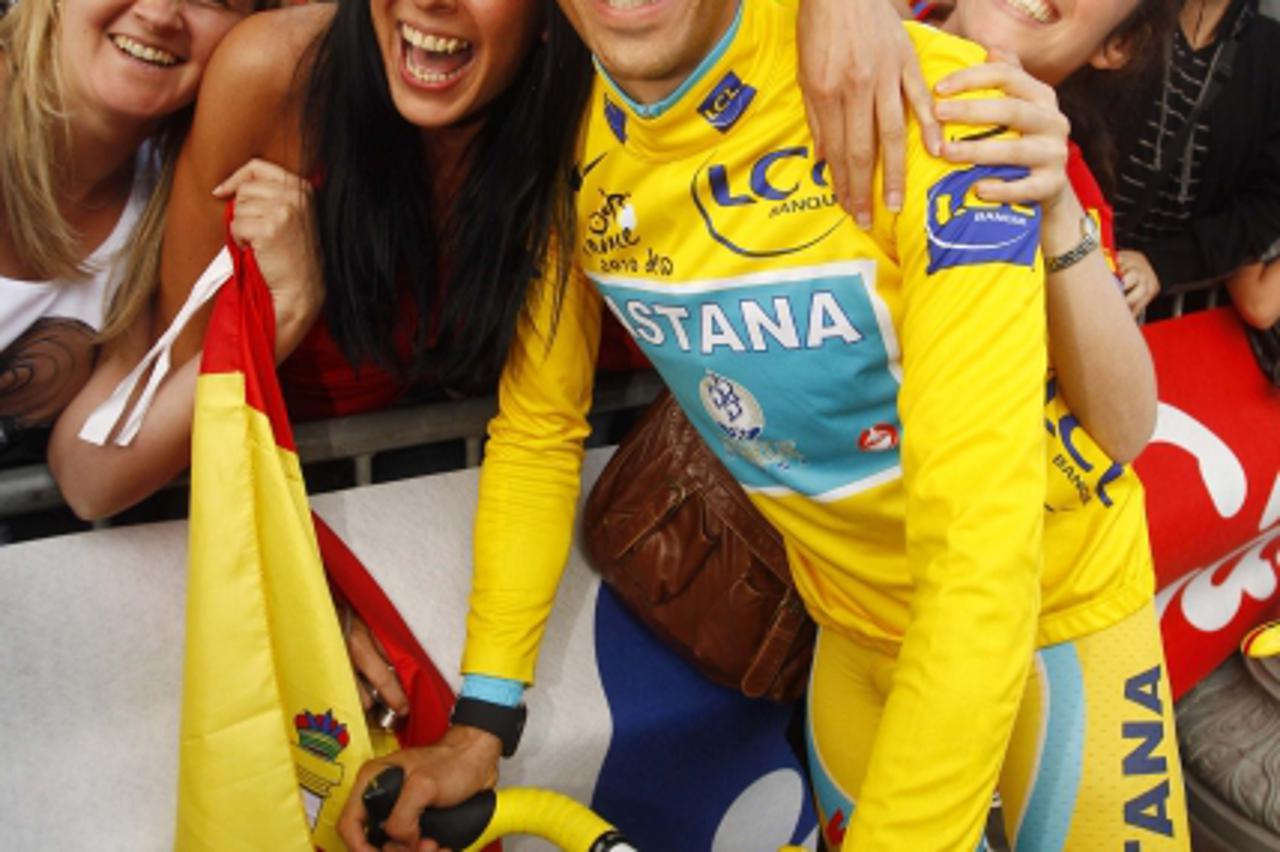 'Astana team rider and leader\'s yellow jersey Alberto Contador of Spain celebrates on the Champs Elysees in Paris after winning the 97th Tour de France cycling race July 25, 2010. Contador won the To