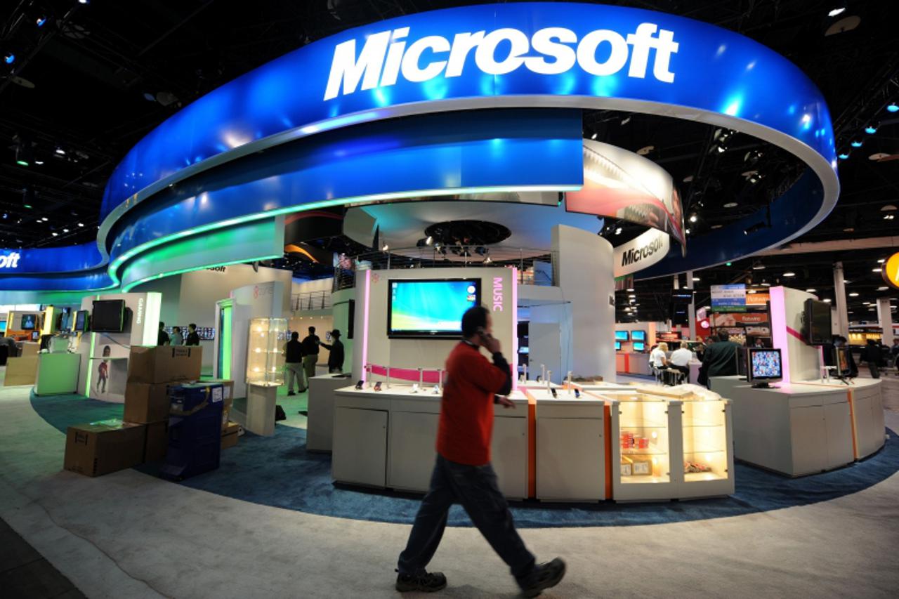 '(FILES) A worker walks past the Microsoft display during set up at the annual Consumer Electronics Show in Las Vegas, Nevada in this January 7, 2009 file photo. Microsoft on June 25, 2012 announced a