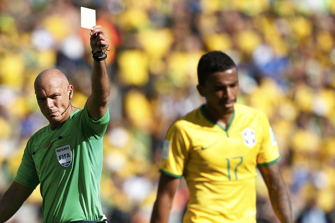 Brazil's Luiz Gustavo (R) receives a yellow card from referee Howard Webb of England during their 2014 World Cup round of 16 game against Chile at the Mineirao stadium in Belo Horizonte June 28, 2014. REUTERS/Toru Hanai (BRAZIL  - Tags: SOCCER SPORT WORLD