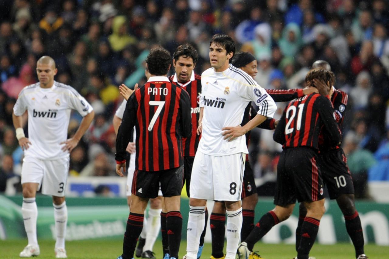 'Real Madrid\'s Brazilian midfielder Kaka (C) looks dejected as A.C. Milan\'s players celebrate the goal of A.C. Milan\'s midfielder Andrea Pirlo during the UEFA Champions League football match betwee