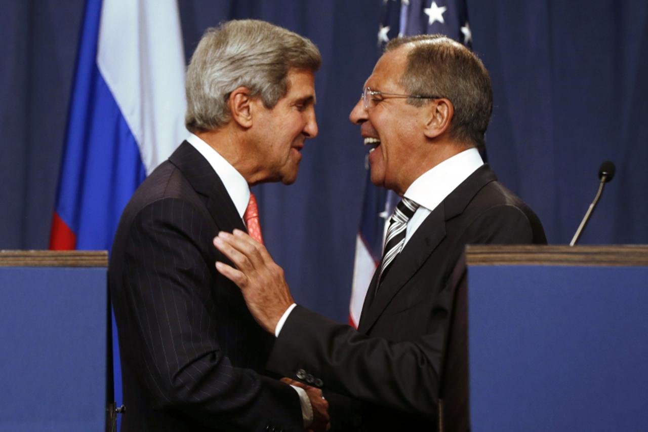'U.S. Secretary of State John Kerry (L) and Russian Foreign Minister Sergei Lavrov (R) shake hands after making statements following meetings regarding Syria, at a news conference in Geneva September 