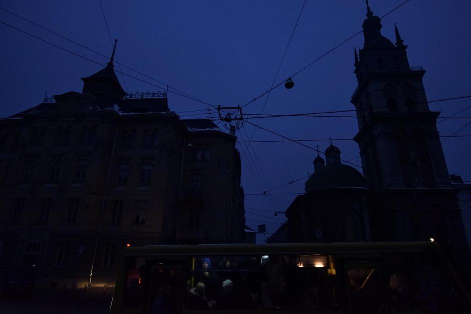 People ride on a bus in the city centre without electricity after critical civil infrastructure was hit by Russian missile attacks in Lviv