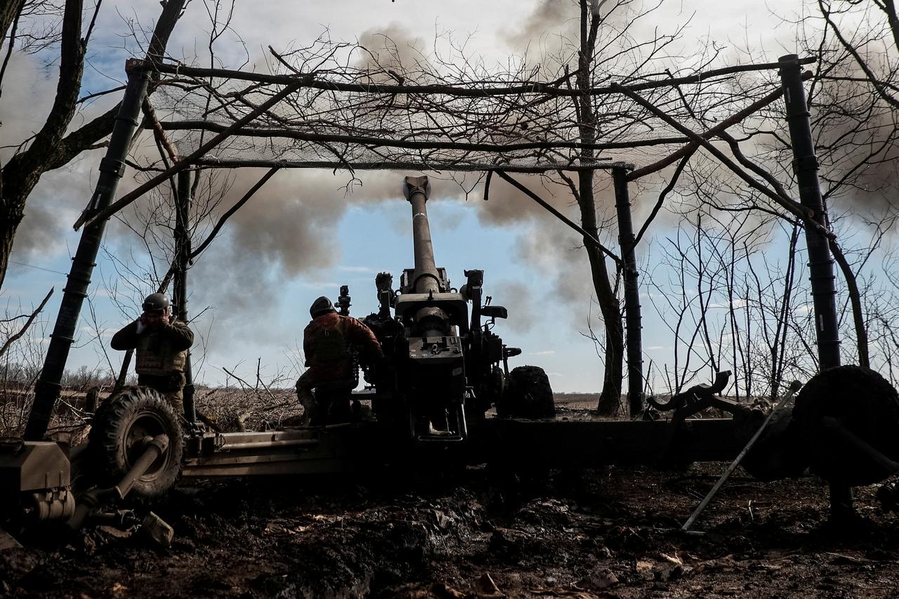 Ukrainian service members fire a shell from a towed howitzer FH-70 at a front line in Zaporizhzhia Region