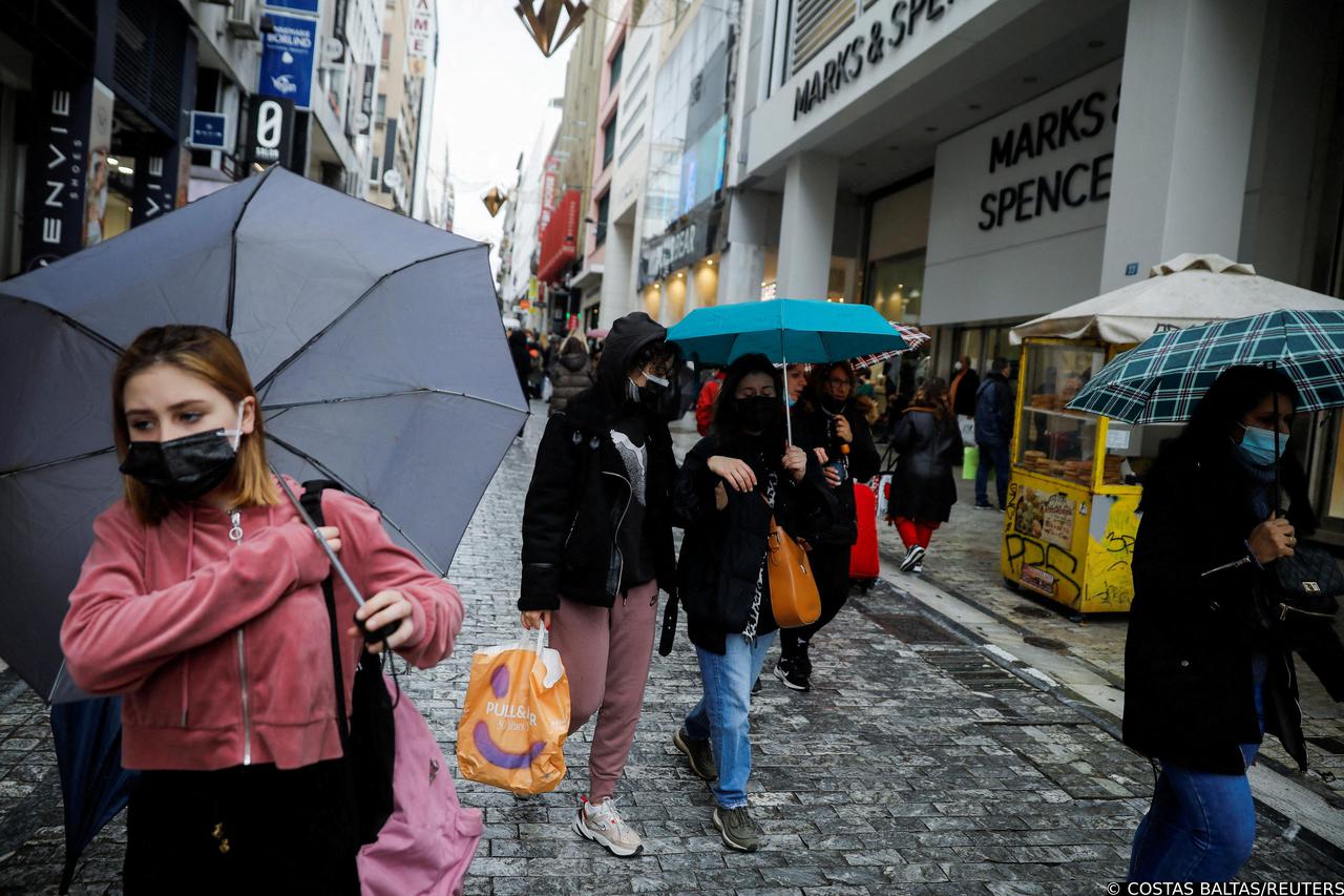 FILE PHOTO: People wearing protective face masks walk on the main Ermou commercial street amid the coronavirus disease (COVID-19) outbreak in Athens