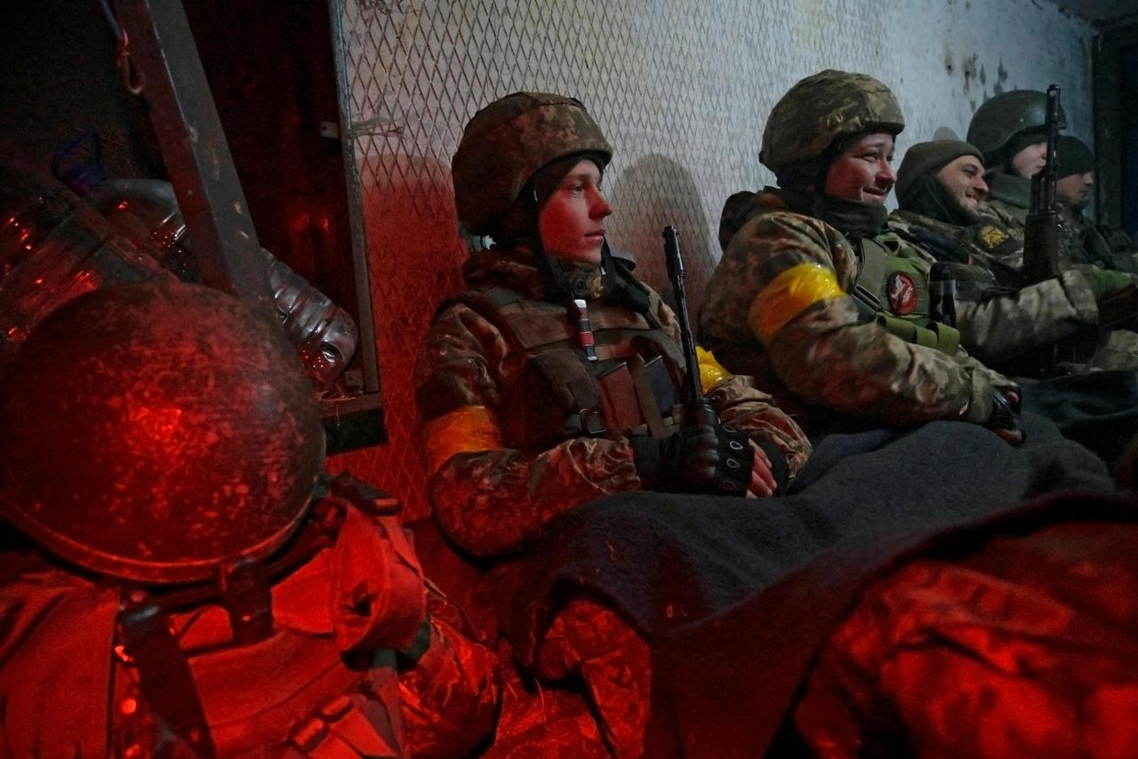 Ukrainian servicemen take cover in a shelter at fighting positions at the military airbase Vasylkiv in the Kyiv region